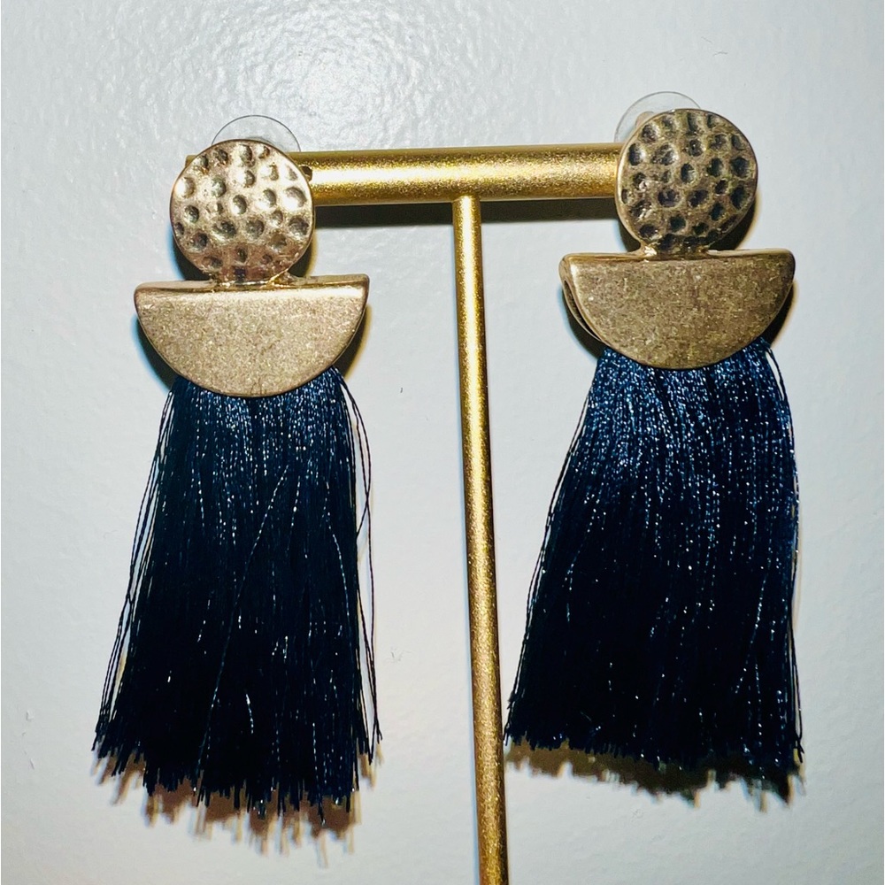 Hammered metal in gold with navy blue tassel